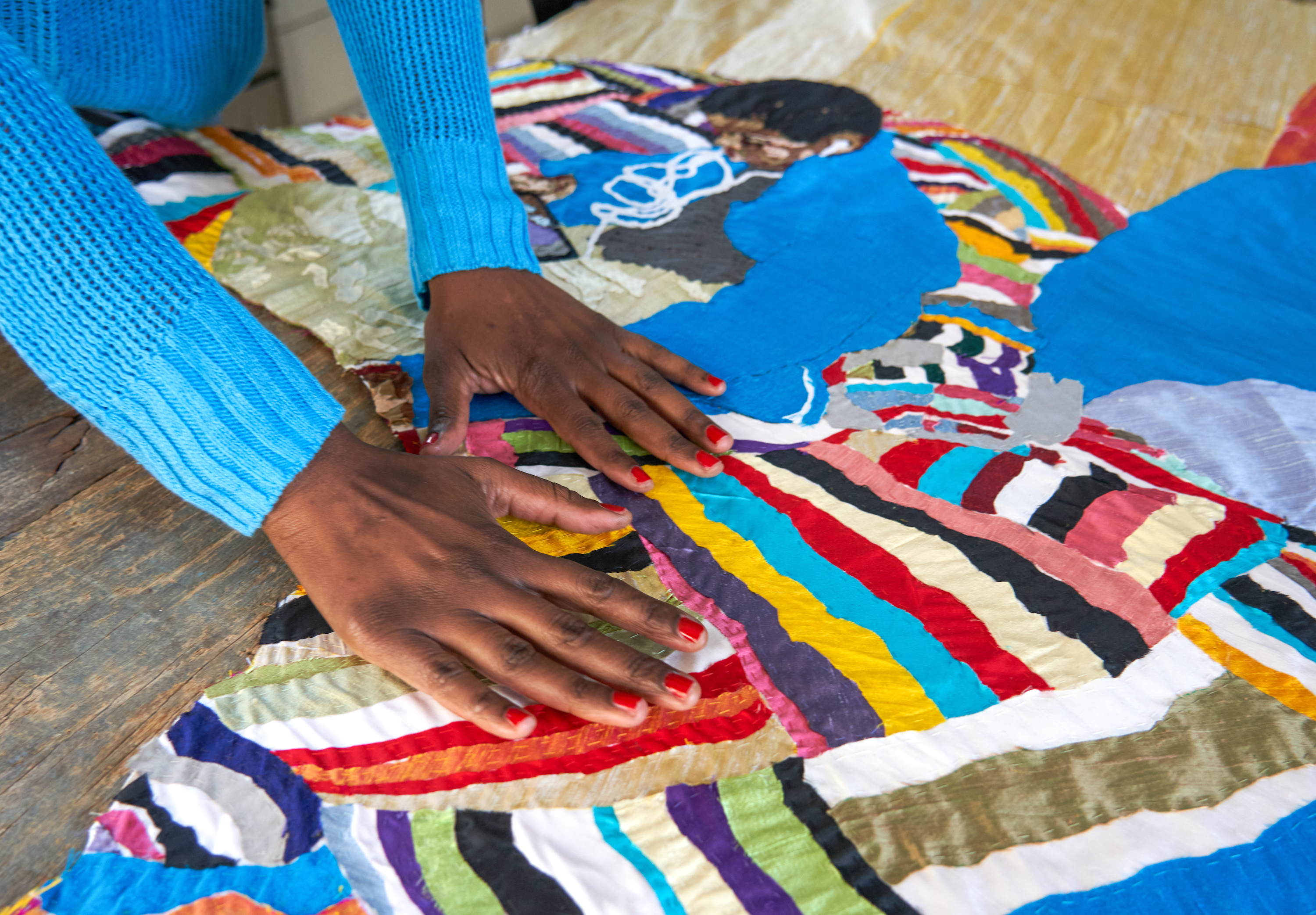 Textile artist Billie Zangewa at work on a quilt piece, as seen in Crafts issue 291 November-December 2021. Photo by Andile Buka